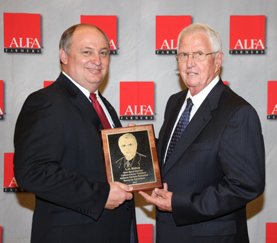 Colbert County Farmers Federation President L.O. Bishop is this year's Service To Agriculture Award winner. The award, presented during the opening session of the Alabama Farmers Federation's 92nd annual meeting, is the highest honor given by the organization. From left are Federation President Jimmy Parnell and Bishop. 