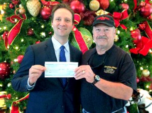 Mr. Einar Gudmundsson, Director of Food and Beverage, Marriott Shoals Hotel & Spa presents Ronnie McDonald, Southern Fishing News, with a $500 check for Operation HOOAH December 17, 2013.