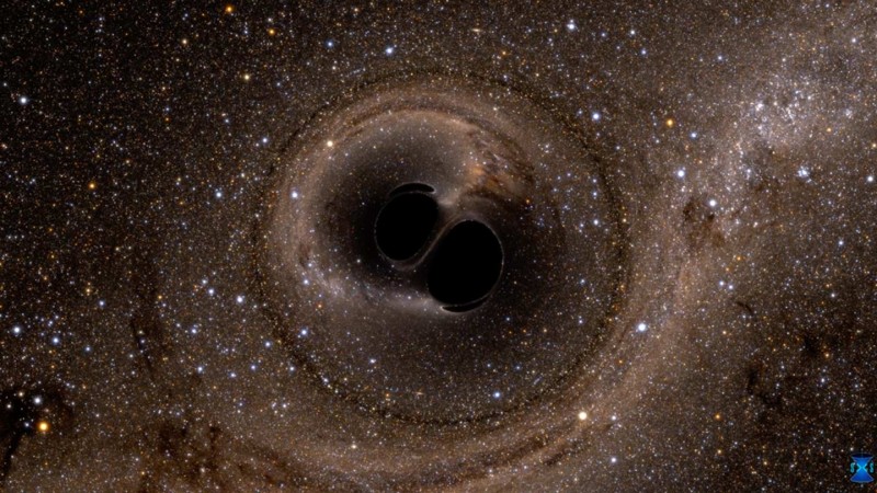 A representative graphic shows two black holes merging. LIGO/SXS