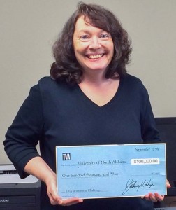 Dr. Kristen Van Renssalaer Holds the ceremonial check from 1998 when TVA presented seed money to begin the Investment Challenge Program at the University of North Alabama. 