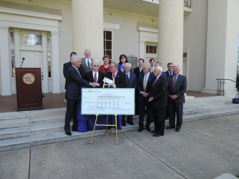 : Bank Independent President Macke Mauldin (left) shakes hand with Athens State President Bob Glenn (right) after unveiling the check that endows the Edward Fennel Mauldin Memorial Endowed Scholarship.