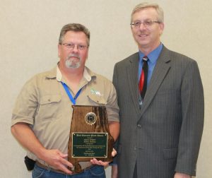  Relief Operator Roger Miller accepts the Best Operated Plant Award from Gary Bailey, past president of the AWPCA. 