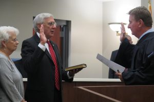 Judge Jerry Batts, far right, swearing in Athens Mayor Ronnie Marks. With Mayor Marks is his wife, Sandra