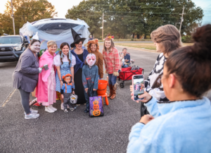 Members of the community pose for a photo while enjoying last year’s Trunk or Treat on the Shoals campus